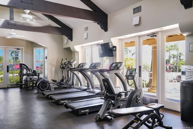 gym featuring arched walkways, french doors, visible vents, vaulted ceiling, and ceiling fan