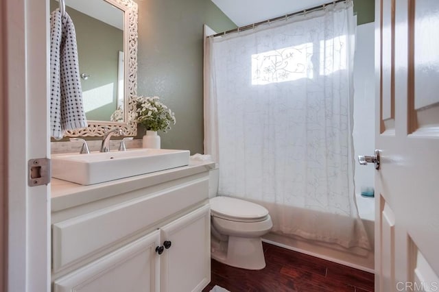 bathroom featuring shower / tub combo, vanity, toilet, and wood finished floors