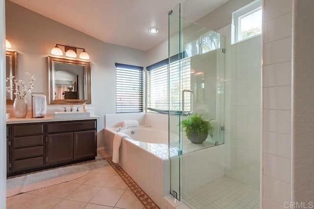 full bathroom featuring a shower stall, plenty of natural light, a garden tub, and tile patterned floors