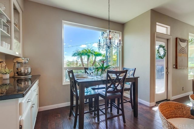 dining area featuring an inviting chandelier, baseboards, and dark wood-type flooring