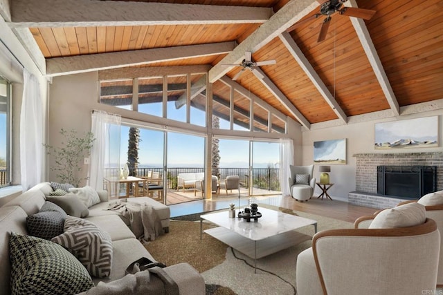 living room featuring wooden ceiling, a fireplace, wood-type flooring, high vaulted ceiling, and beam ceiling