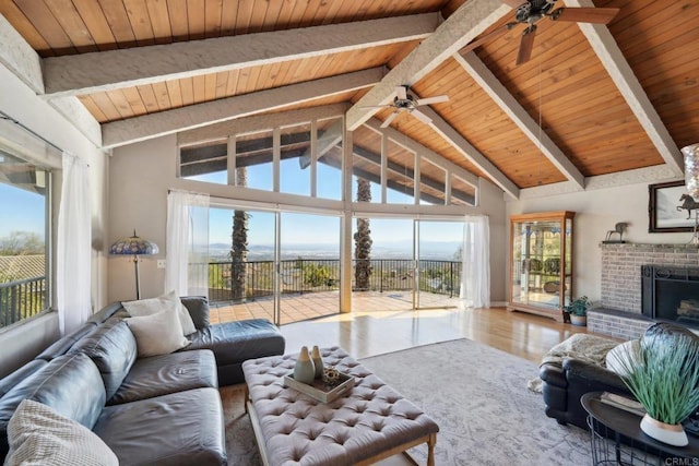 living room featuring wooden ceiling, plenty of natural light, and beam ceiling