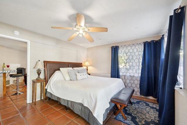 bedroom with ceiling fan and tile patterned floors