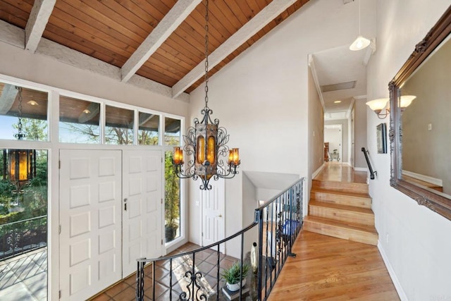 entryway featuring high vaulted ceiling, wooden ceiling, a wealth of natural light, and beam ceiling