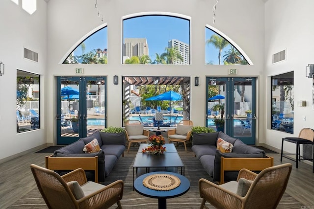 sunroom / solarium featuring a healthy amount of sunlight and french doors