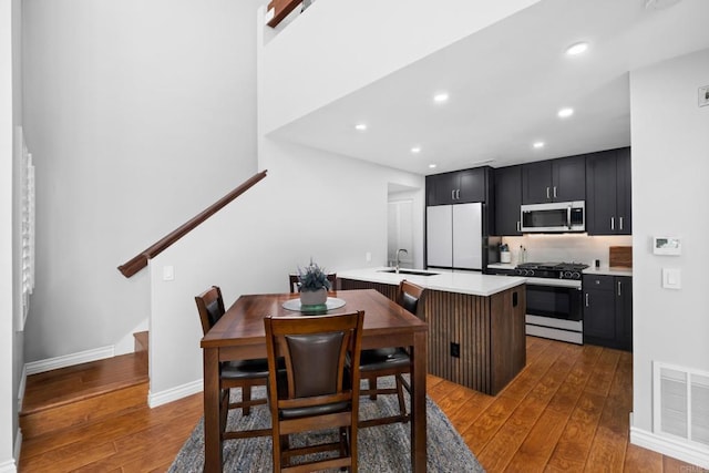 dining area with hardwood / wood-style floors and sink