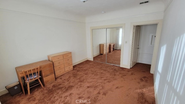 bedroom featuring a closet and dark colored carpet