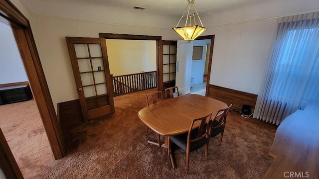 dining room featuring dark carpet and french doors