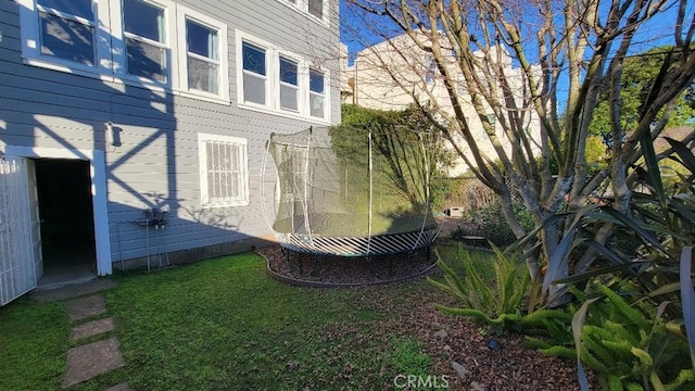 exterior space with a lawn and a trampoline