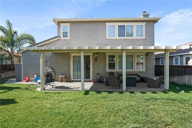 back of property featuring an outdoor hangout area, a patio area, and a yard