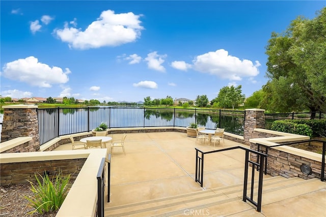 view of patio / terrace with a water view and a fire pit