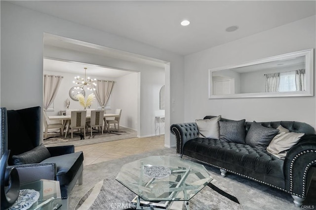 living room with light tile patterned floors and a chandelier