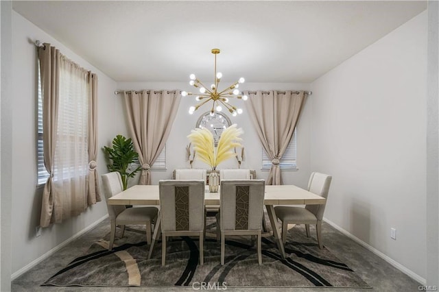 dining room featuring a chandelier and carpet floors