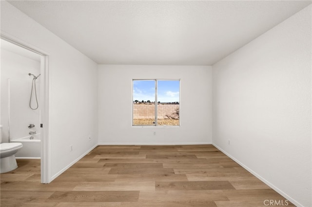 unfurnished room with light wood-type flooring