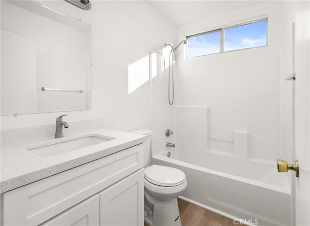 full bathroom featuring toilet,  shower combination, hardwood / wood-style floors, and vanity