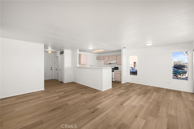 unfurnished living room with a textured ceiling and light hardwood / wood-style flooring