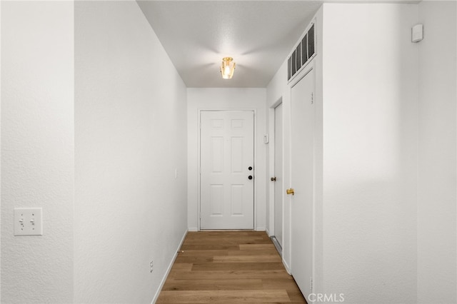 corridor featuring wood-type flooring