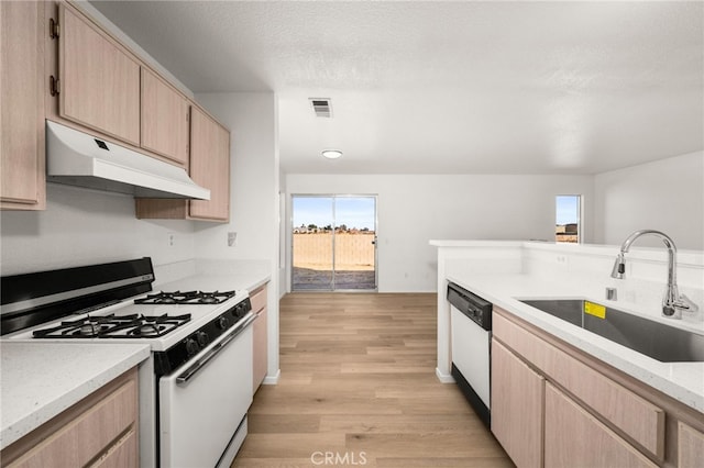 kitchen with dishwasher, sink, white range with gas cooktop, light wood-type flooring, and light brown cabinets