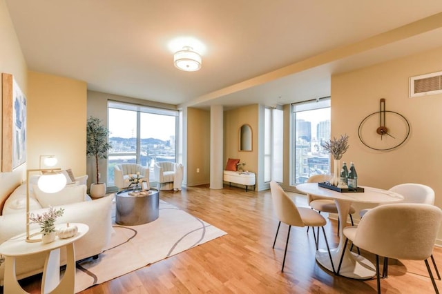 interior space featuring floor to ceiling windows, plenty of natural light, and light wood-type flooring