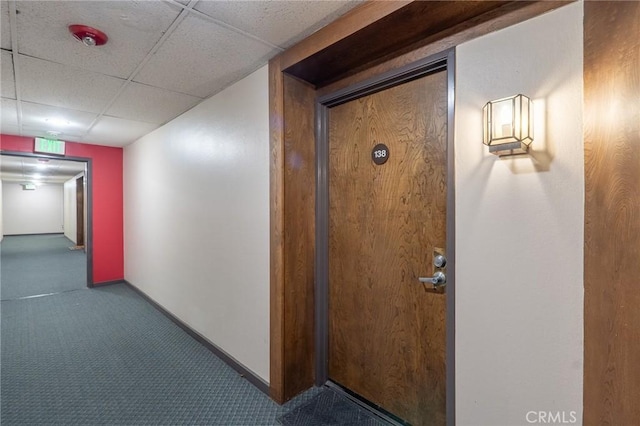 22100 Burbank Blvd Unit 138D, Woodland Hills, CA 91367 - hallway with carpet floors, a paneled ceiling, and baseboards