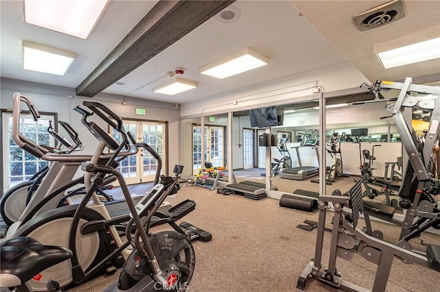 exercise room featuring french doors and carpet floors