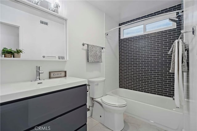 full bathroom featuring toilet, vanity, and tiled shower / bath