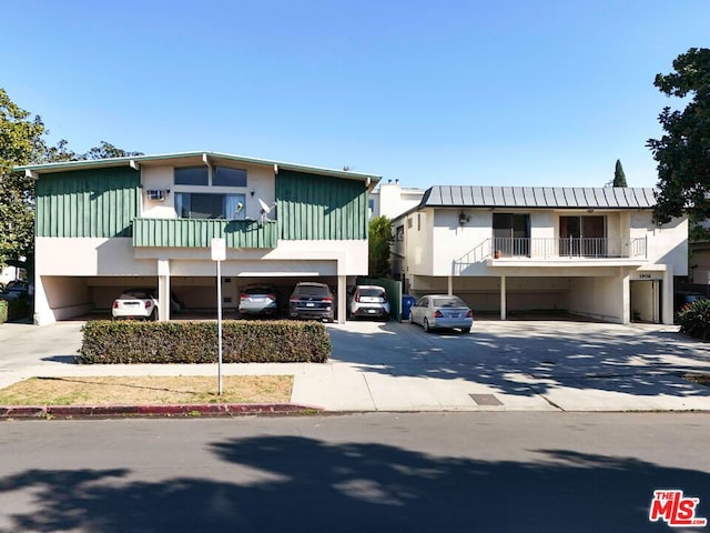 view of front facade featuring a balcony and a garage