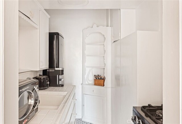 clothes washing area featuring washer / dryer