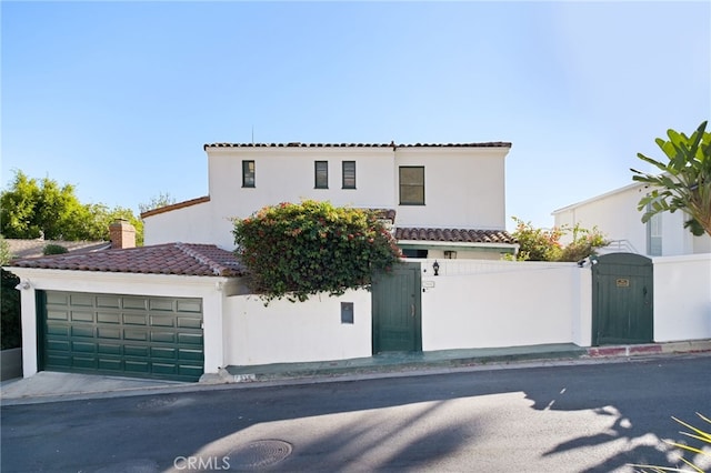 mediterranean / spanish house featuring a garage