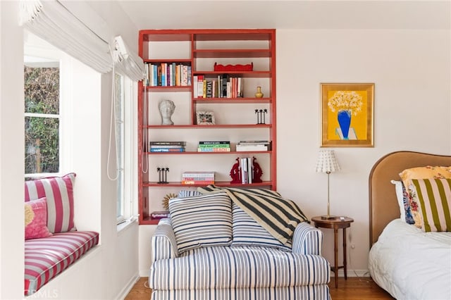 sitting room with hardwood / wood-style flooring and a healthy amount of sunlight