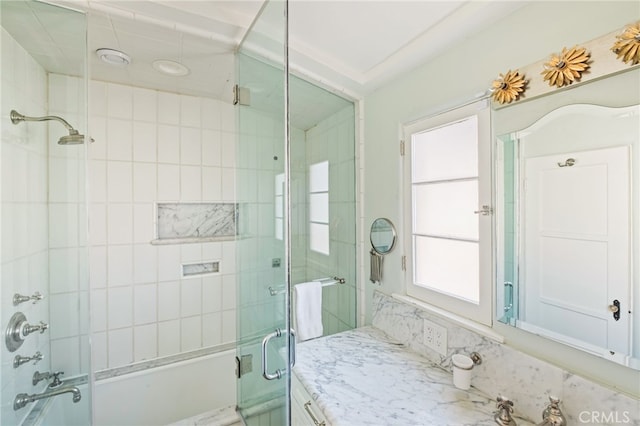 bathroom featuring vanity and bath / shower combo with glass door