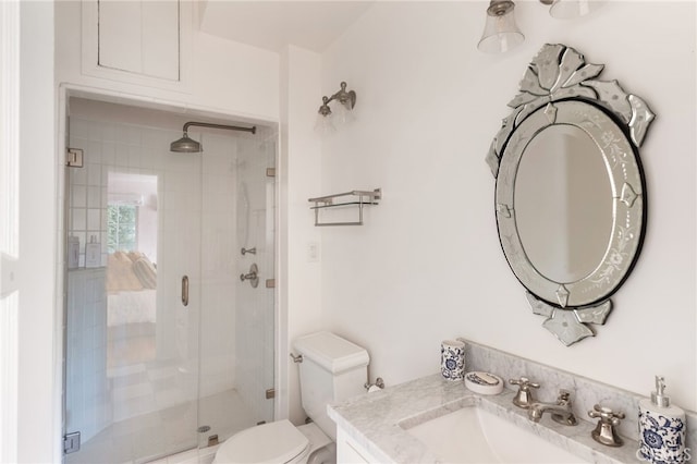 bathroom featuring walk in shower, vanity, and toilet