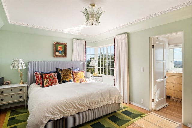 bedroom featuring hardwood / wood-style floors and a chandelier