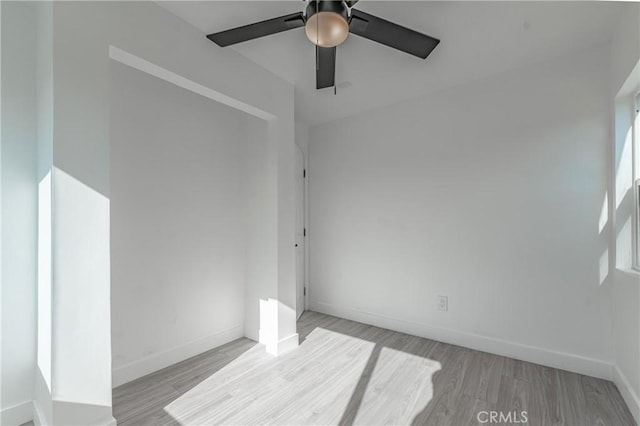 spare room featuring ceiling fan and light hardwood / wood-style flooring