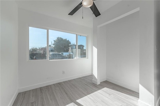 spare room featuring light hardwood / wood-style floors, plenty of natural light, and ceiling fan