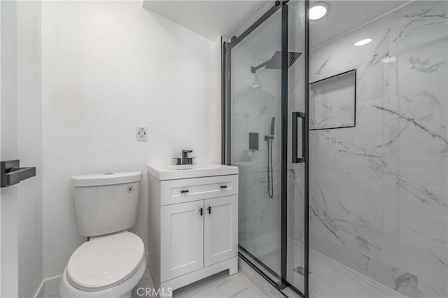 bathroom featuring a shower with shower door, toilet, and vanity