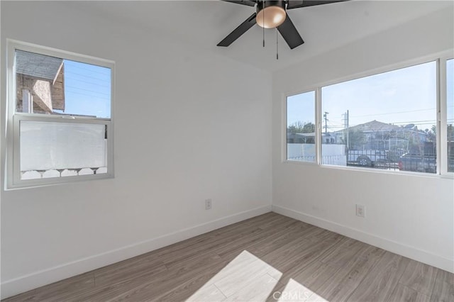 empty room featuring ceiling fan and light hardwood / wood-style floors