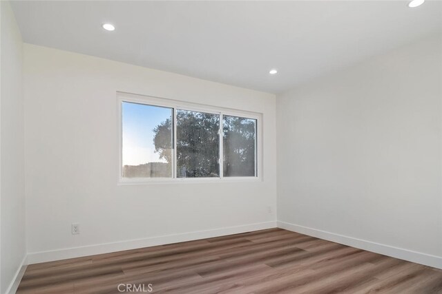 empty room with dark hardwood / wood-style flooring