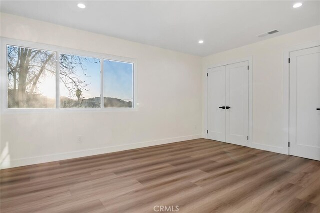 unfurnished bedroom featuring hardwood / wood-style floors