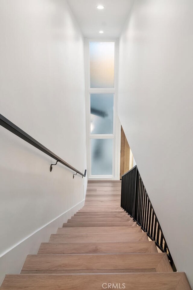 stairs with hardwood / wood-style floors