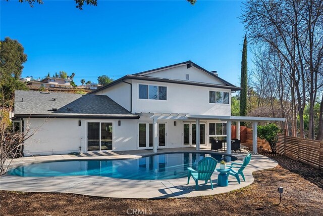 back of property with a pergola and a patio