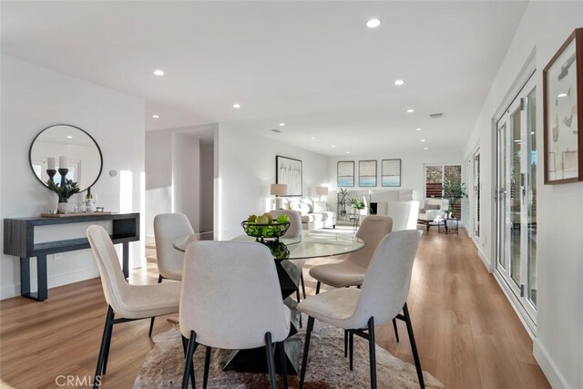 dining area featuring light wood-type flooring