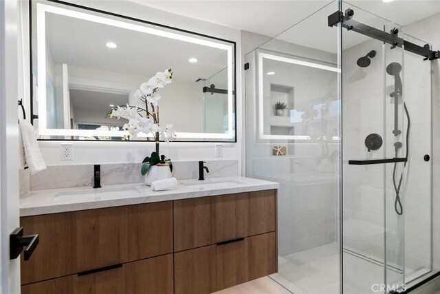 bathroom with walk in shower and vanity