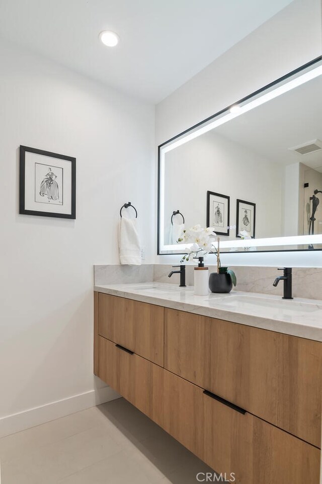 bathroom with tile patterned floors and vanity