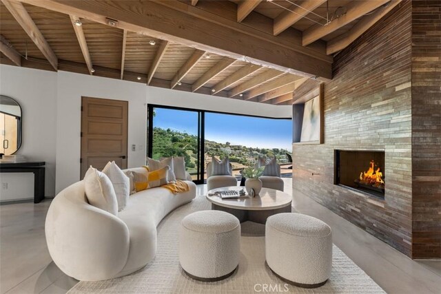 living room with wooden ceiling, beam ceiling, and a fireplace