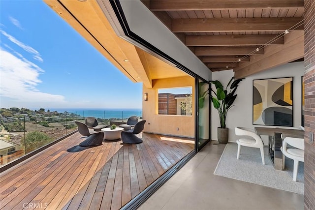 wooden terrace featuring a water view