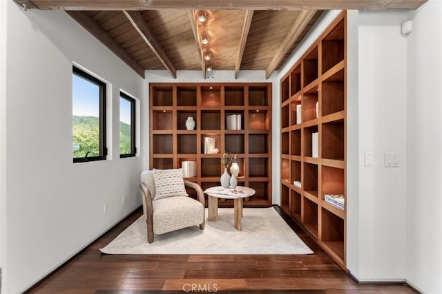 living area with wooden ceiling, hardwood / wood-style flooring, and lofted ceiling with beams