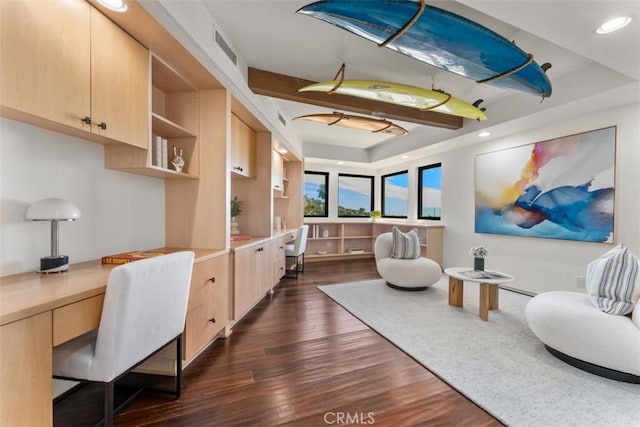 office area featuring built in desk, dark hardwood / wood-style floors, and beamed ceiling