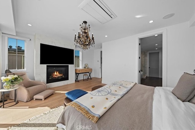 bedroom featuring a chandelier and light hardwood / wood-style flooring