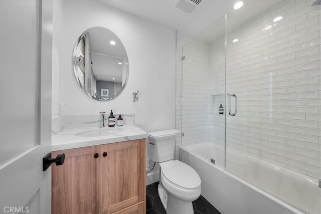 full bathroom featuring enclosed tub / shower combo, toilet, and vanity